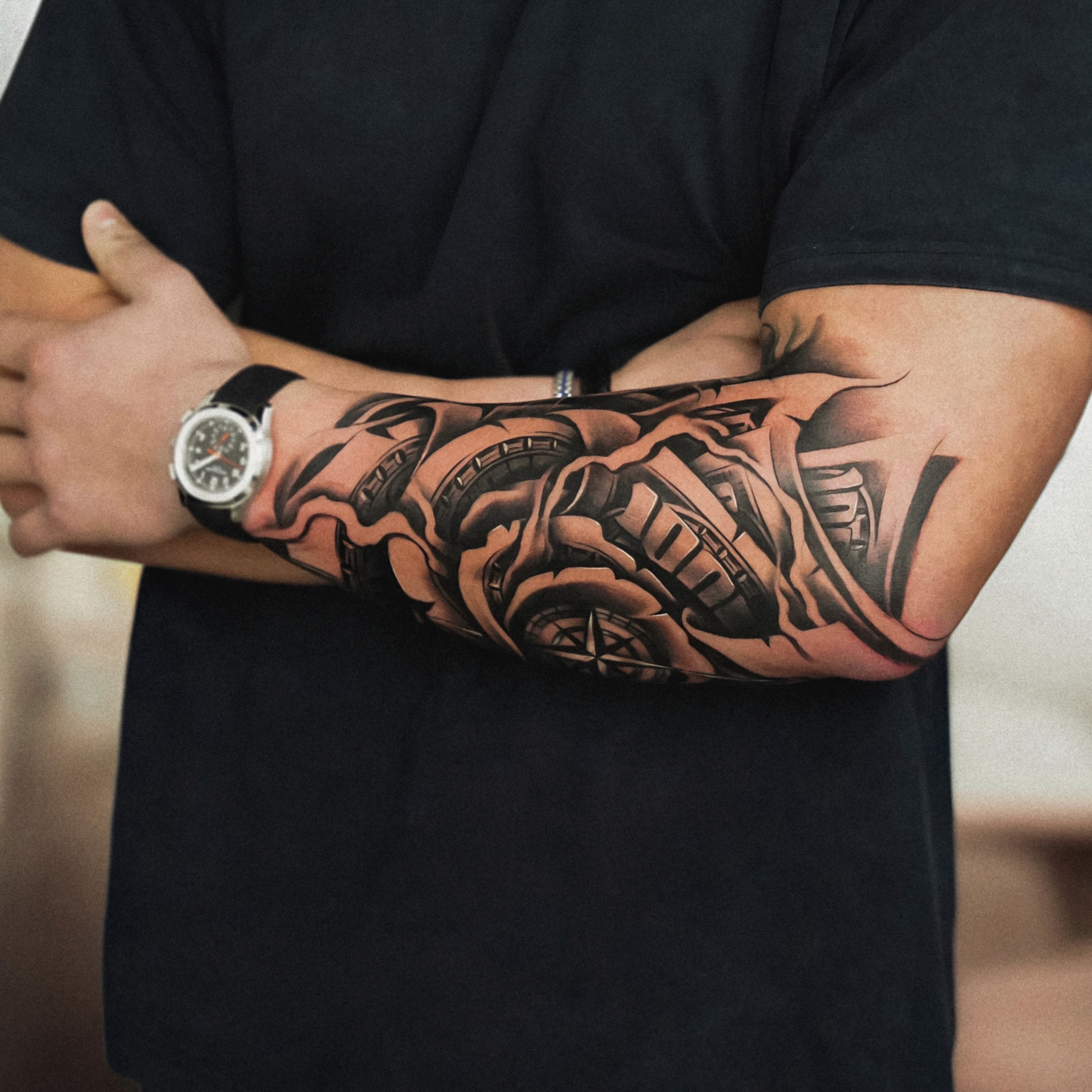Client with arms crossed showing a finished biomechanical forearm sleeve