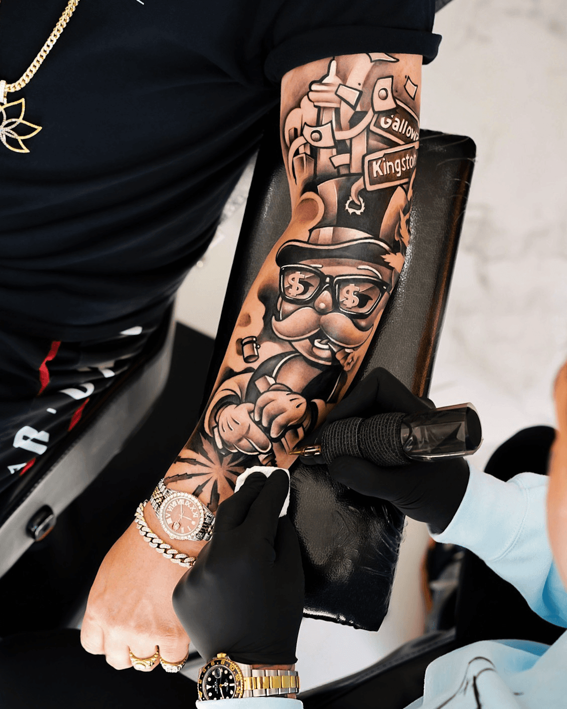Overhead view of Kristian Vendler working on a full forearm sleeve
