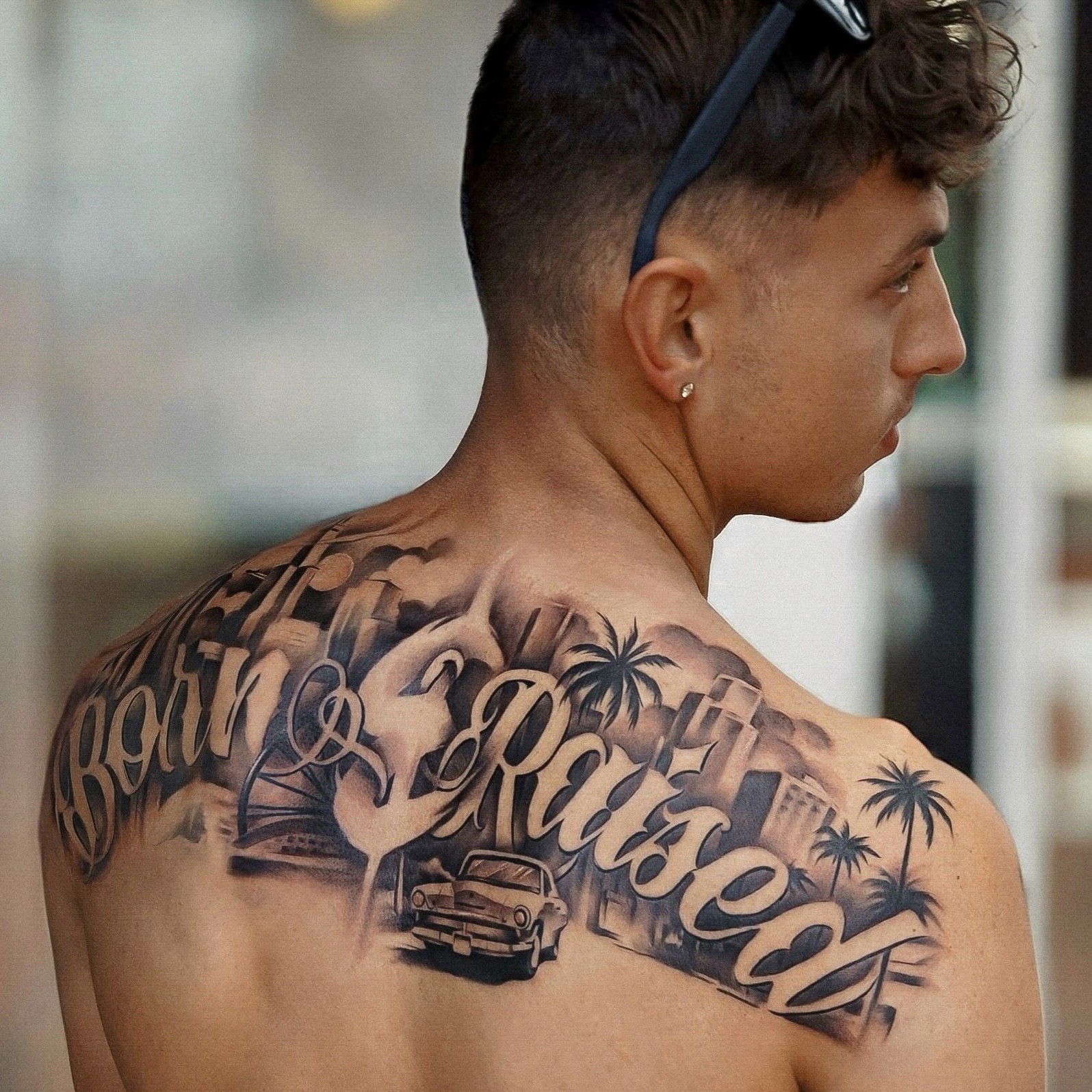 Shoulder to shoulder Born and Raised script back piece with palm trees and lowrider