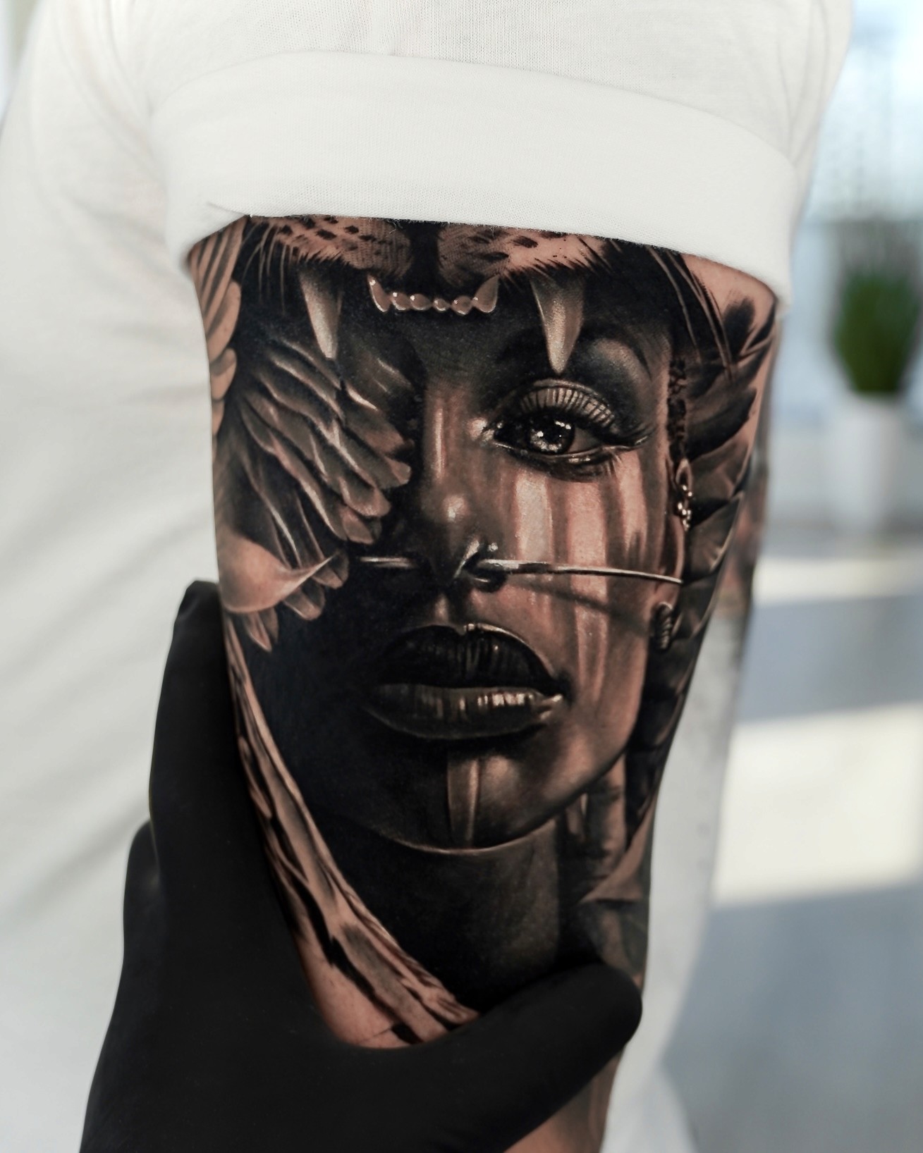 Black and grey realism tattoo of a woman wearing a jaguar pelt headdress